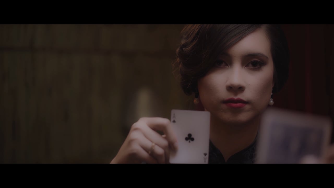 A woman holding a playing card in the 2046 tribute trailer