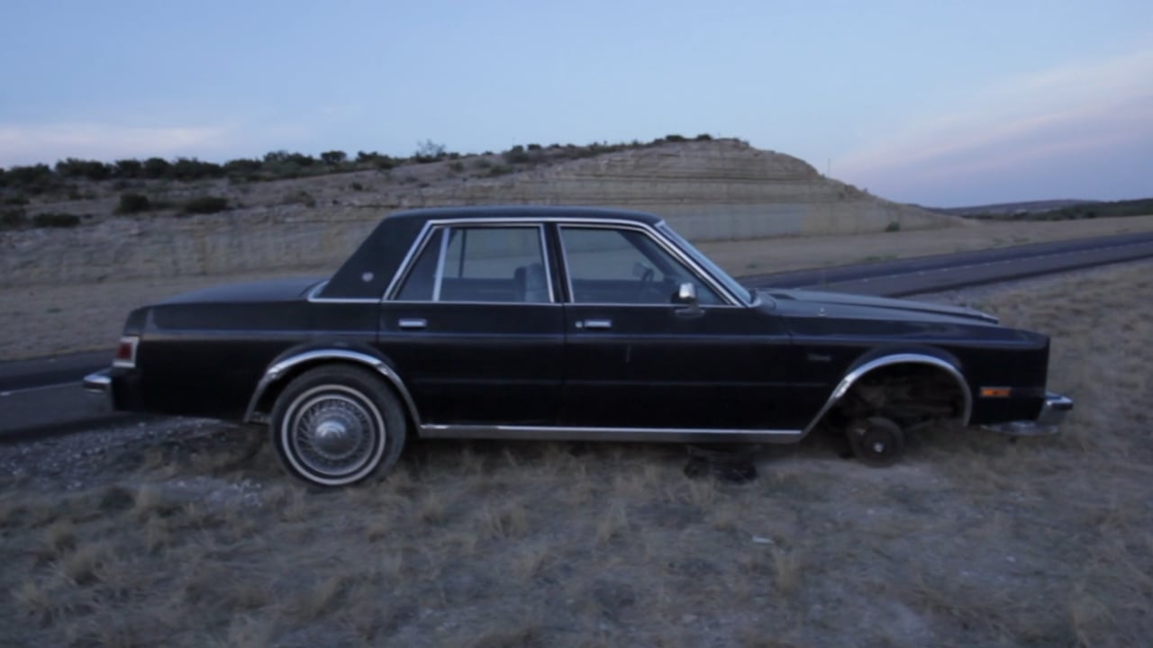 A black car on a rural Texas road in the 2018 Demo Reel