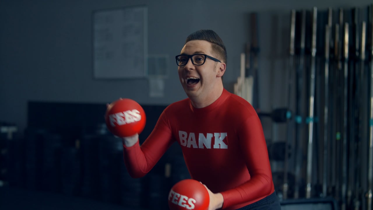 A performer in a red bank-fees costume